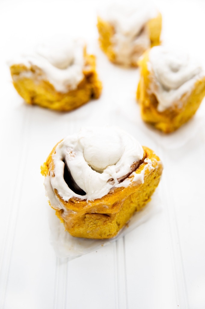 Soft, pillowy pumpkin cinnamon rolls topped with a tangy cream cheese frosting. Perfect for a weekend breakfast! | via Broma Bakery | #stickybuns