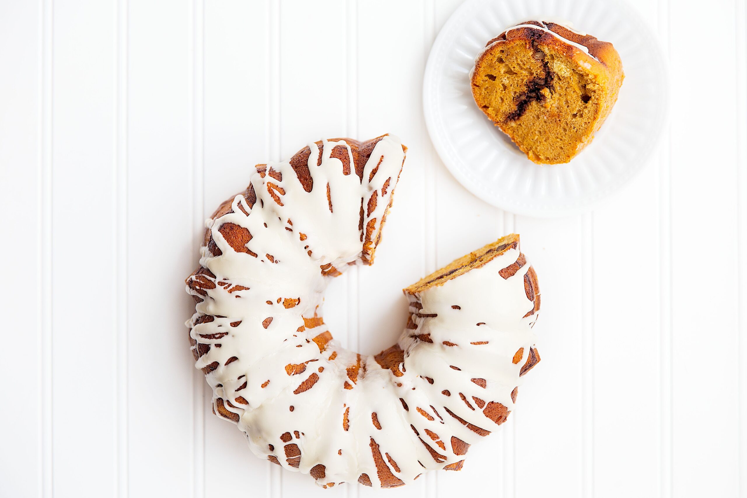 A spiced sweet potato bundt cake with pecan streusel and topped with a maple syrup glaze | via Broma Bakery | #sweetpotato #bundtcake