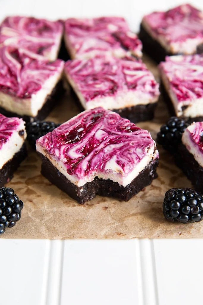 Blackberry cheesecake brownies on a cutting board