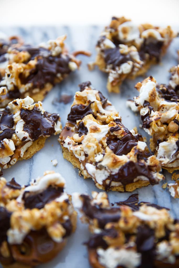 This loaded bark is made with graham crackers, pretzels, peanuts, toffee, popcorn, chocolate, and toasted marshmallows. Betcha can't eat just one!