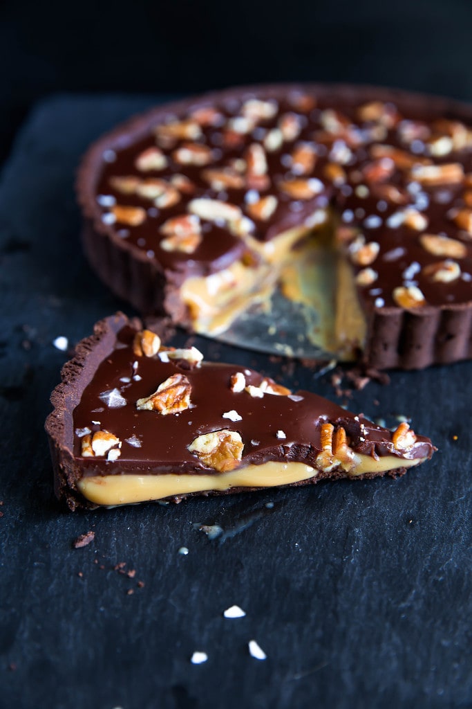 Salted Caramel Chocolate Tart has a chocolate pretzel crust, salted caramel center, and is topped with melted chocolate, pecans, and sea salt. Uhm, swoon?!
