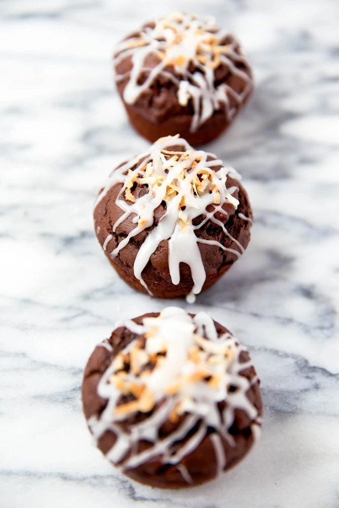 Fluffy Double Chocolate Coconut Muffins made with coconut oil and topped with a coconut drizzle!