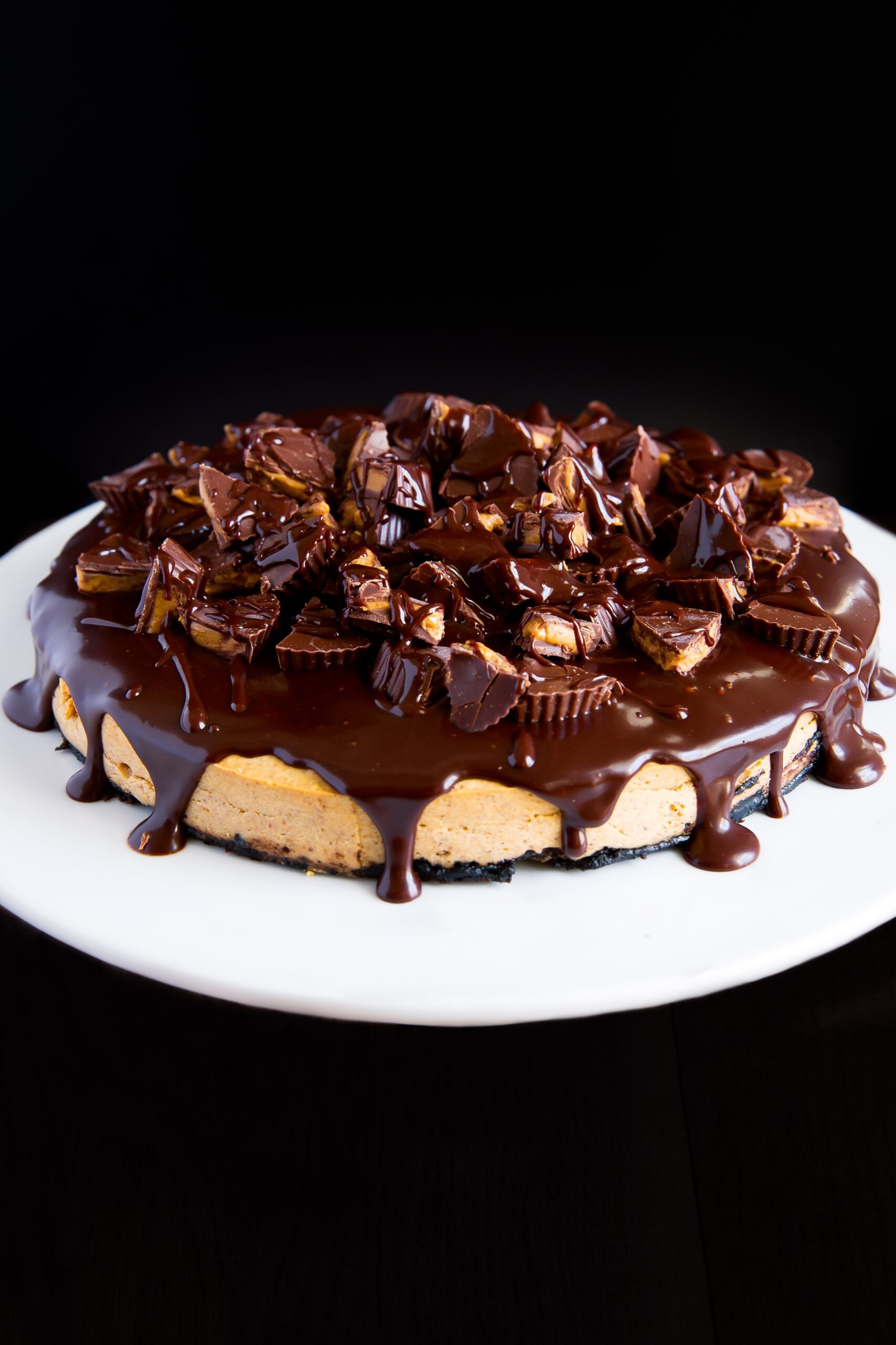 A Peanut Butter Cup Cheesecake with chocolate cookie crust, peanut butter cheesecake filling, and topped with a chocolate ganache and peanut butter cups!
