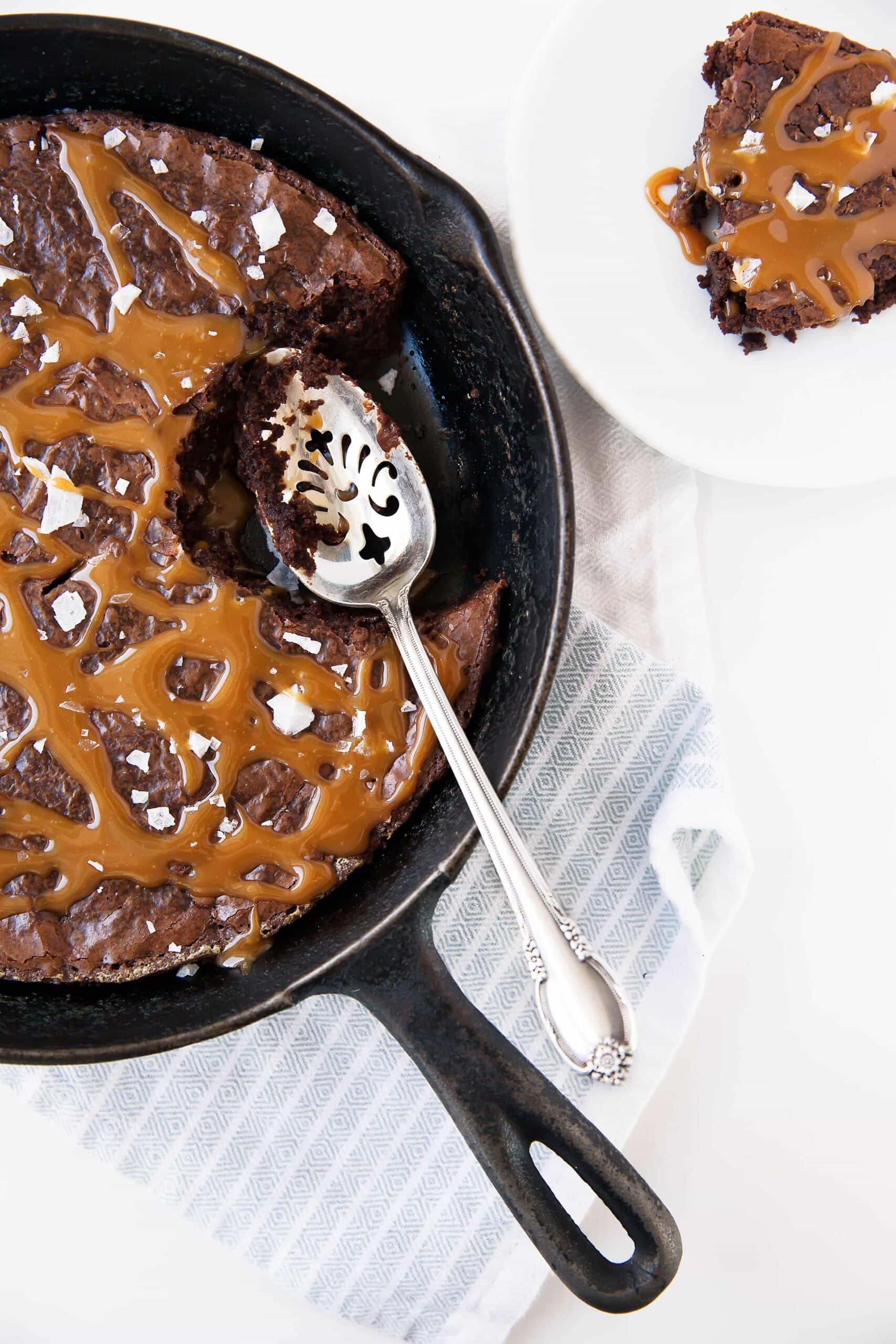 Salted Caramel Skillet Brownie: the fudgiest brownie laden with homemade salted caramel and baked in a caste iron pan!