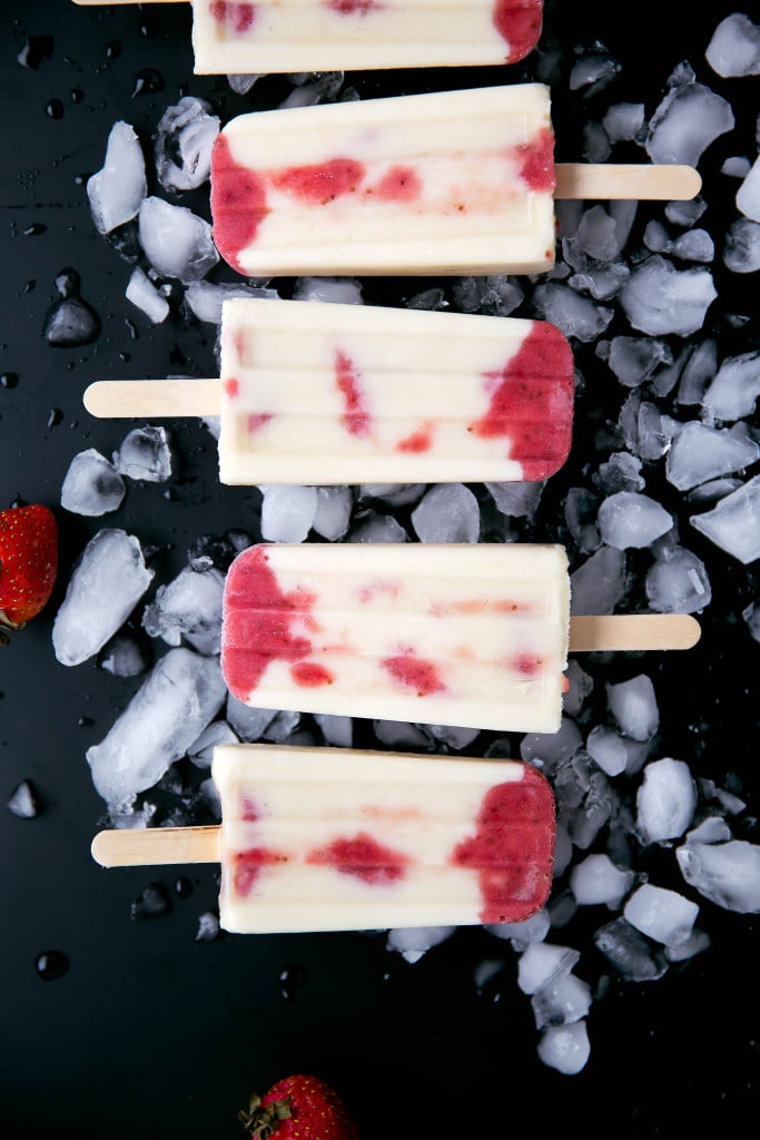 Skinny Strawberries and Cream Popsicles: layers of roasted strawberries and greek yogurt make these popsicles a bikini-welcome summer treat!