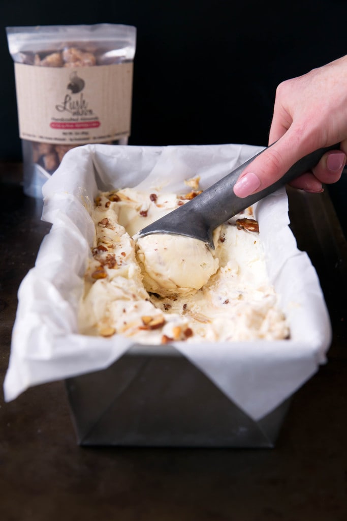 scooping mascarpone ice cream from a pan