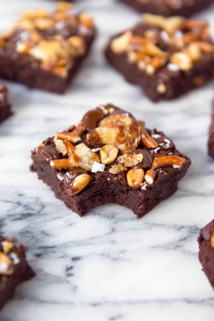 When you're hungry, The Munchies Brownies got you covered: fudgy brownies topped with a sweet and salty combination of pretzels, peanuts, chocolate, potato chips, and sea salt!