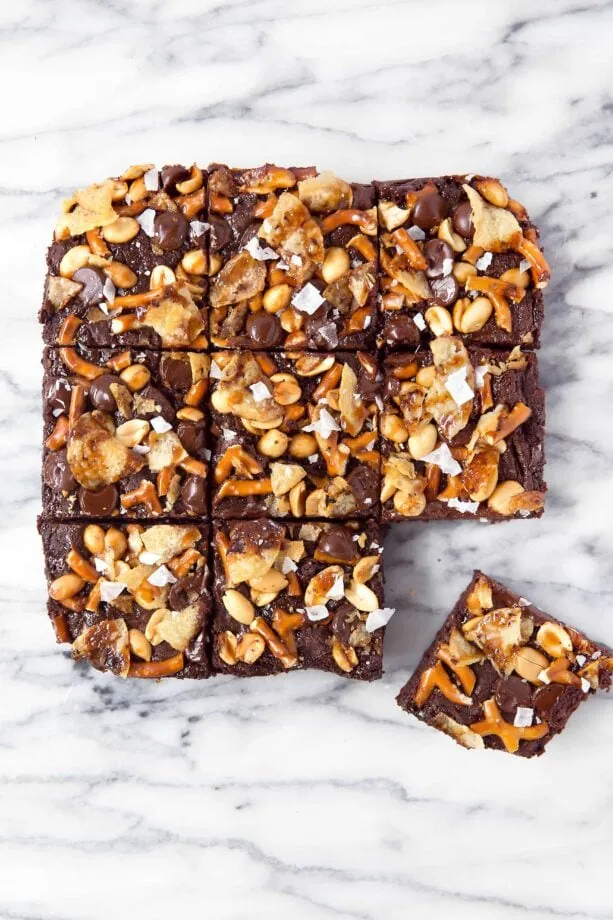 When you're hungry, The Munchies Brownies got you covered: fudgy brownies topped with a sweet and salty combination of pretzels, peanuts, chocolate, potato chips, caramel, and sea salt!