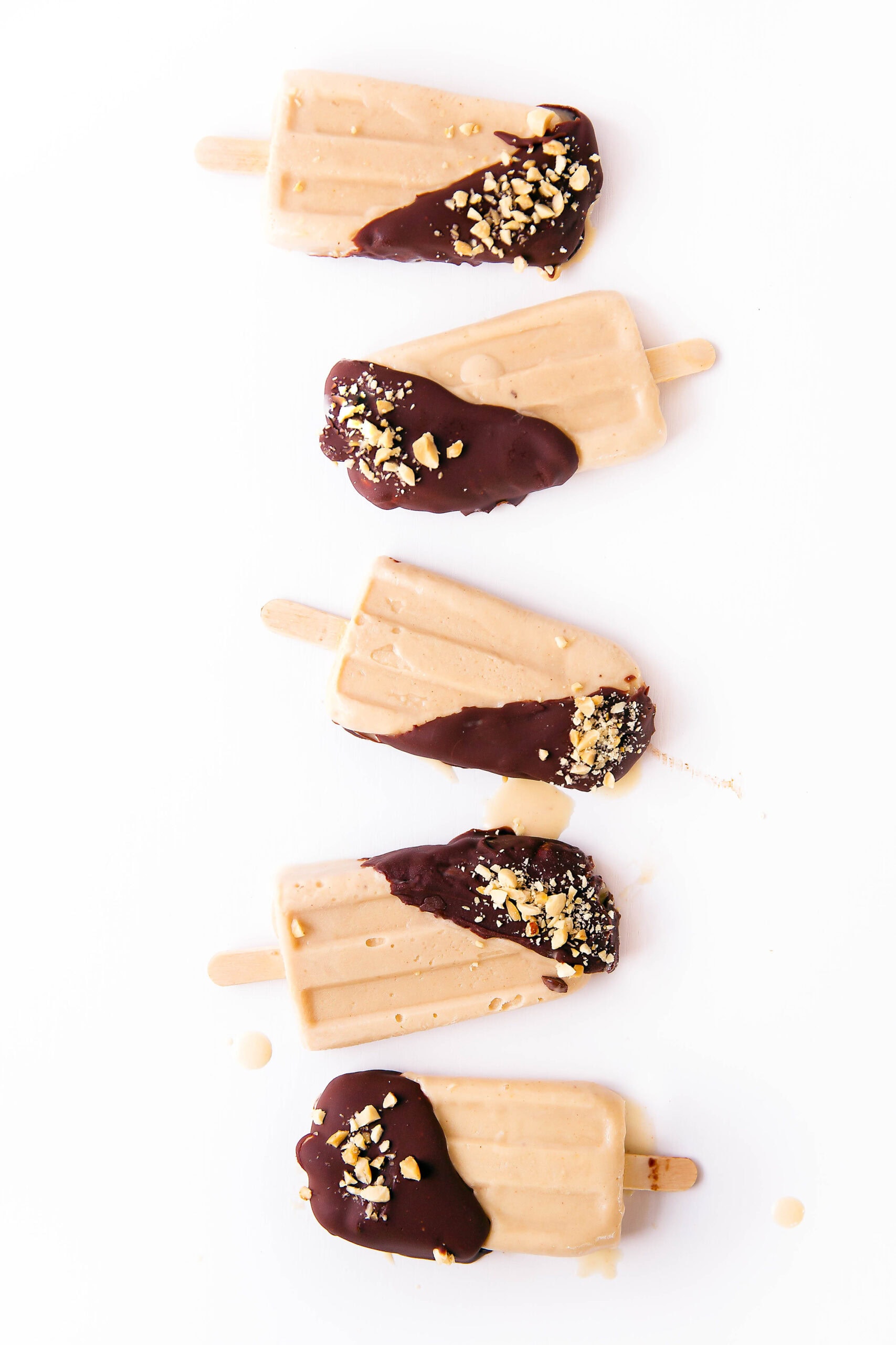 Elvis's favorite combo, peanut butter and banana, come together in popsicle form along with a sinful dip of chocolate in these Elvis Popsicles!