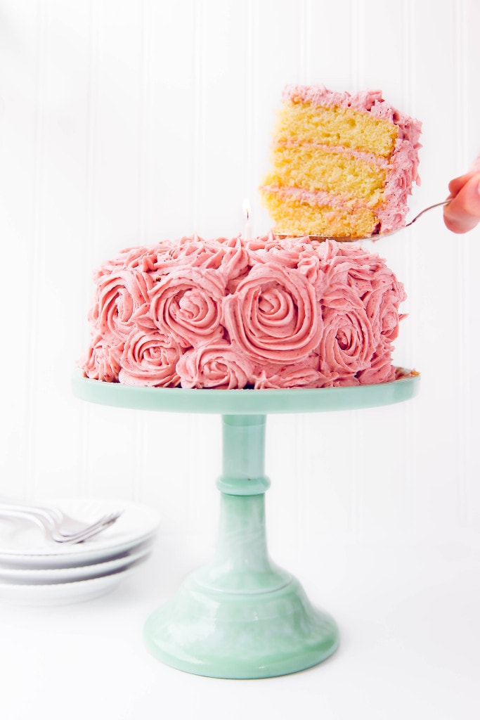 serving a slice of Almond Strawberry Cake with Strawberry Buttercream