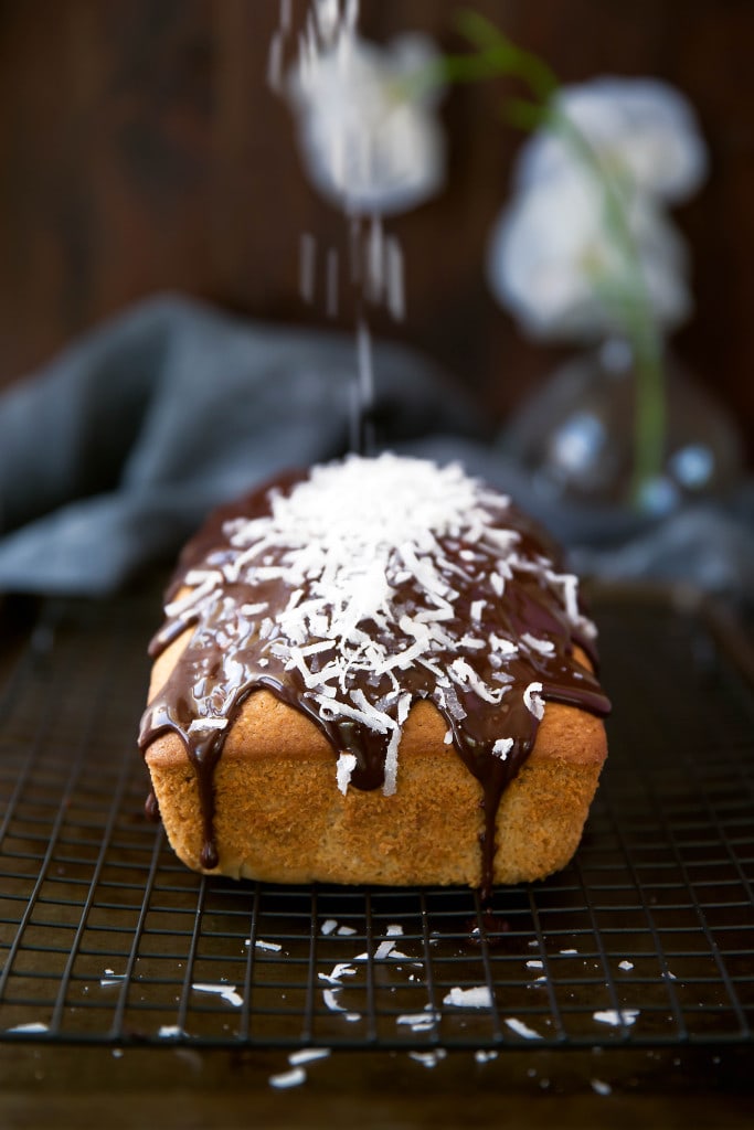 One hour is all it takes for this moist coconut loaf drizzled with chocolate ganache and shredded coconut! 