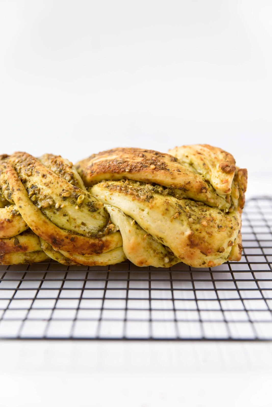 Parmesan Pesto Bread: a braided loaf slathered in homemade pesto and parmesan. Perfect for a late summer night.