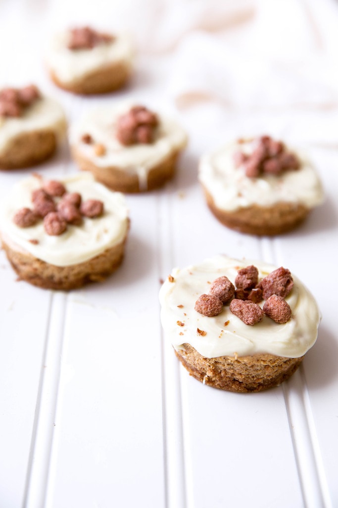 Mini pumpkin spice cheesecakes topped with a white chocolate ganache and cinnamon candied peanuts!