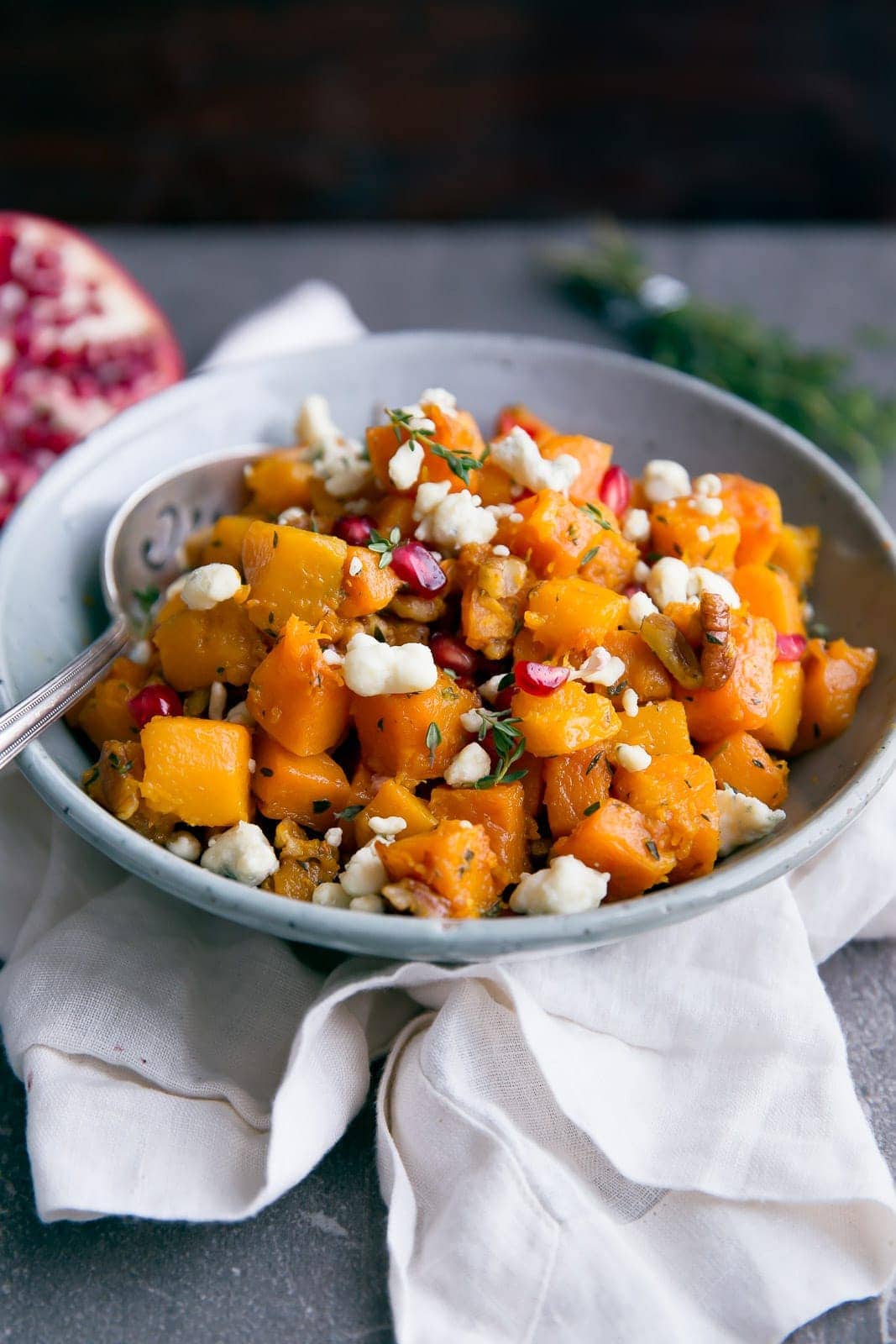 A side dish worthy of center stage: deliciously roasted butternut squash tossed with gorgonzola, pecans, and pomegranate!