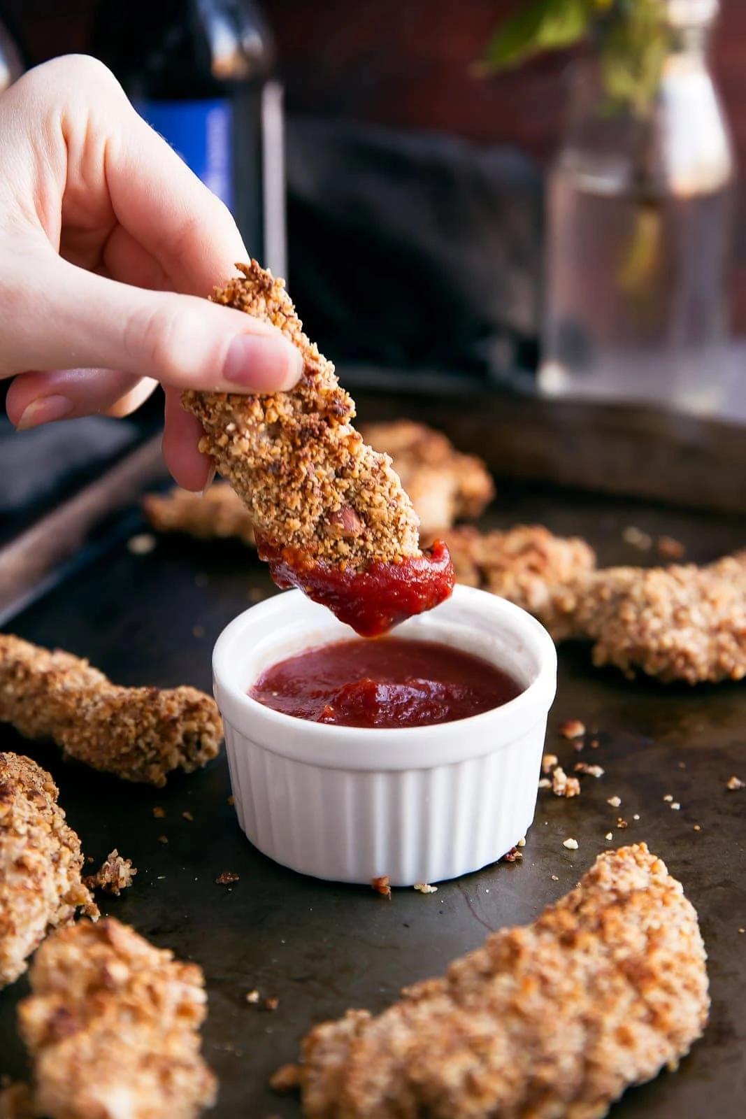 dunking a Wasabi-Almond Crusted Chicken Tender into ketchup