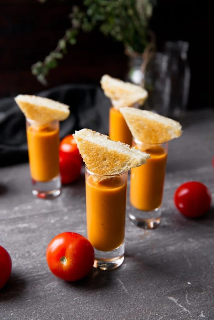 tomato bisque shooters topped with grilled cheese triangles