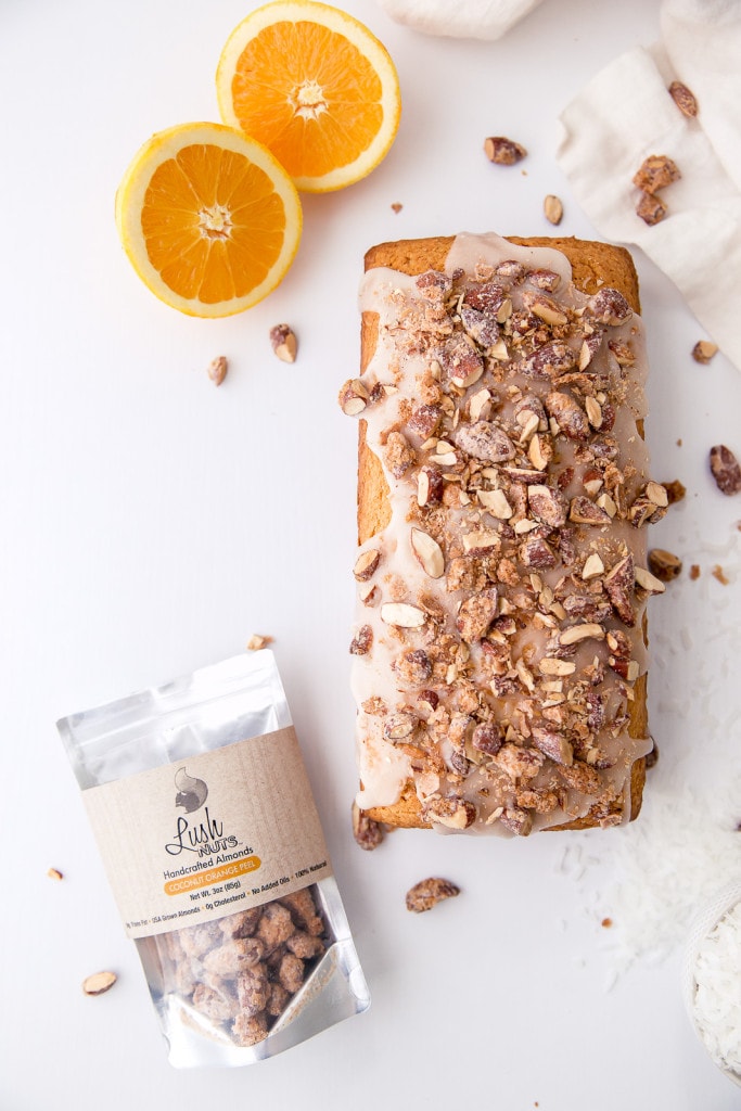 A tropical coconut orange bread topped with coconut glaze and candied coconut orange almonds!