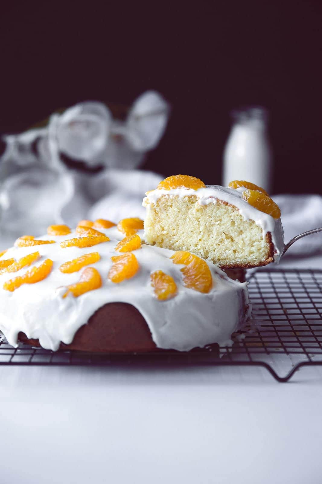 An easy weekday cake: one bowl lemon cake with a coconut cream icing and mandarin orange slices.