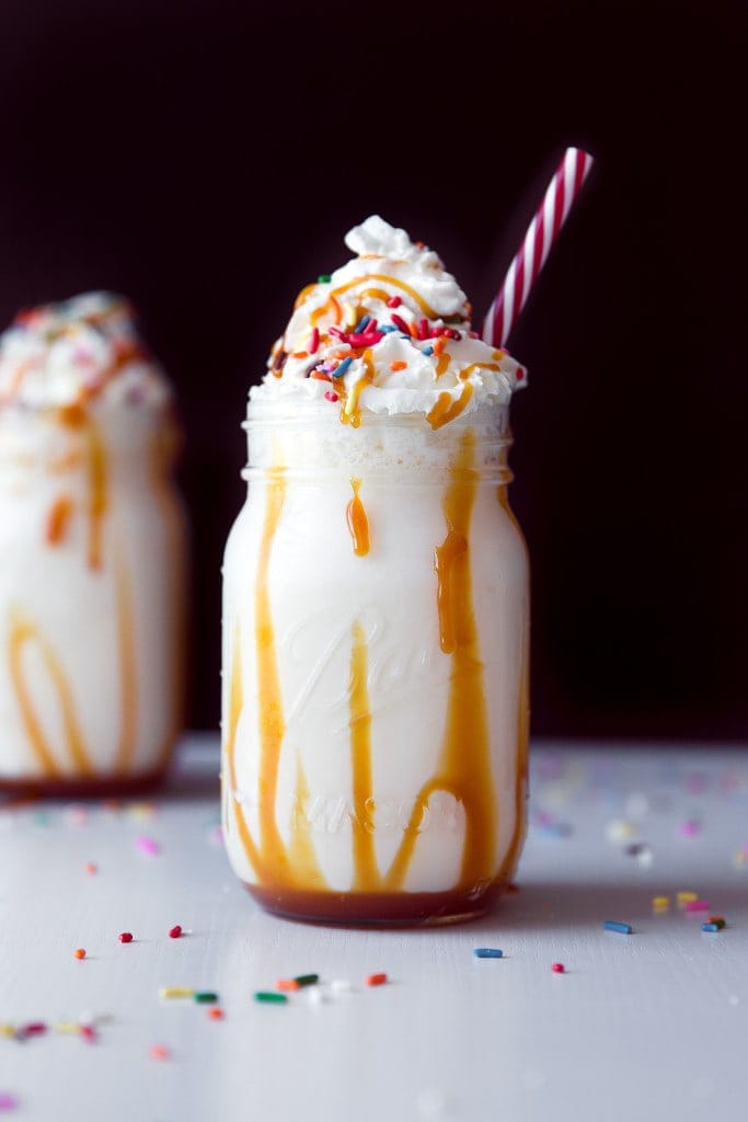 caramel milkshake topped with whipped cream and sprinkles