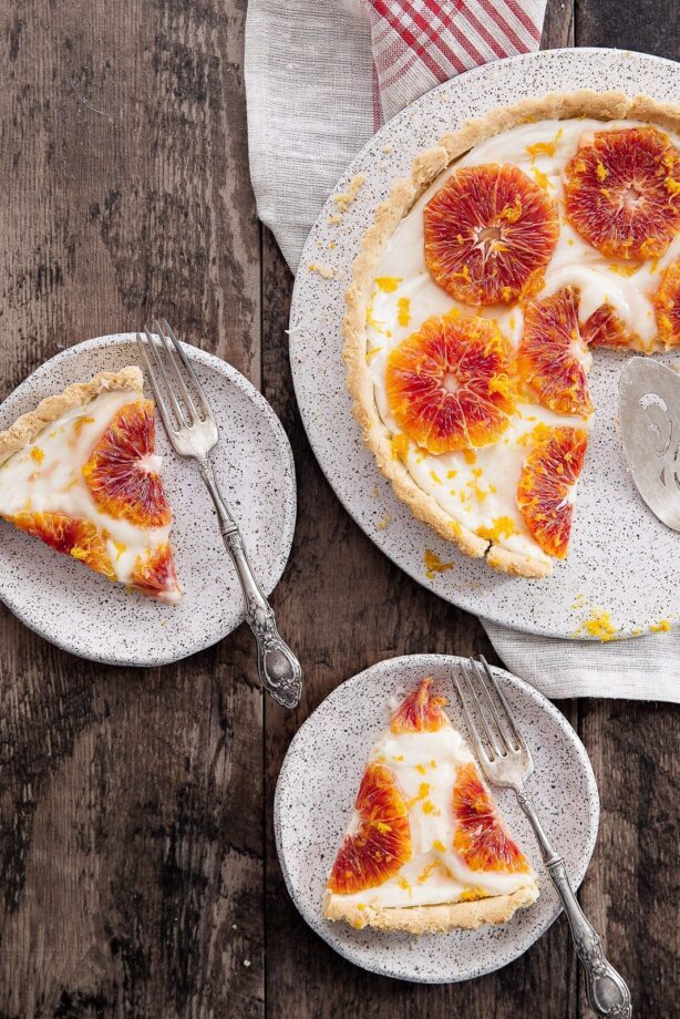 A flakey tart with cream cheese filling and topped with candied ginger blood oranges.