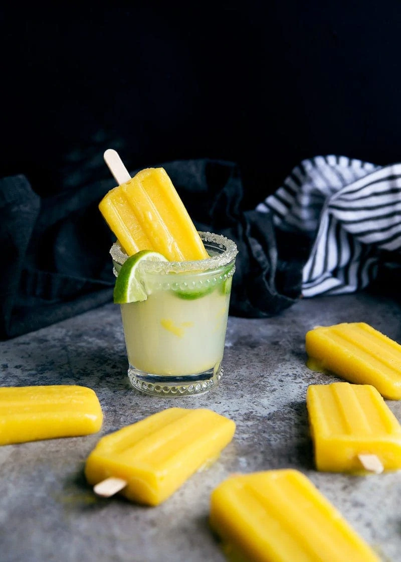 Forget ice cubes, we're dipping Jalapeño Mango Margarita Popsicles into our drinks! Perfect for Cinco de Mayo!
