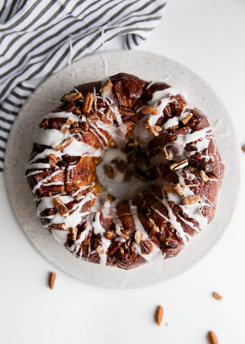 A soft and pillowy buttered rum monkey bread covered in cinnamon sugar, pecans, and topped with rum icing. So, like, can I have this every weekend?