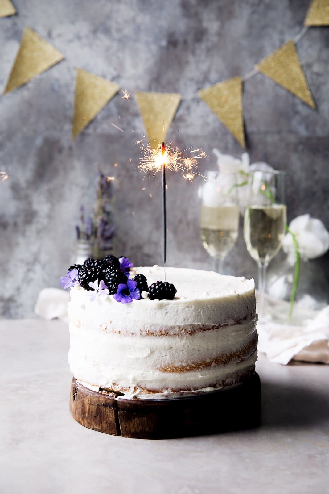 A soft vanilla cake layered with raspberry jam and vanilla CHAMPAGNE FROSTING. Let's get this party started.