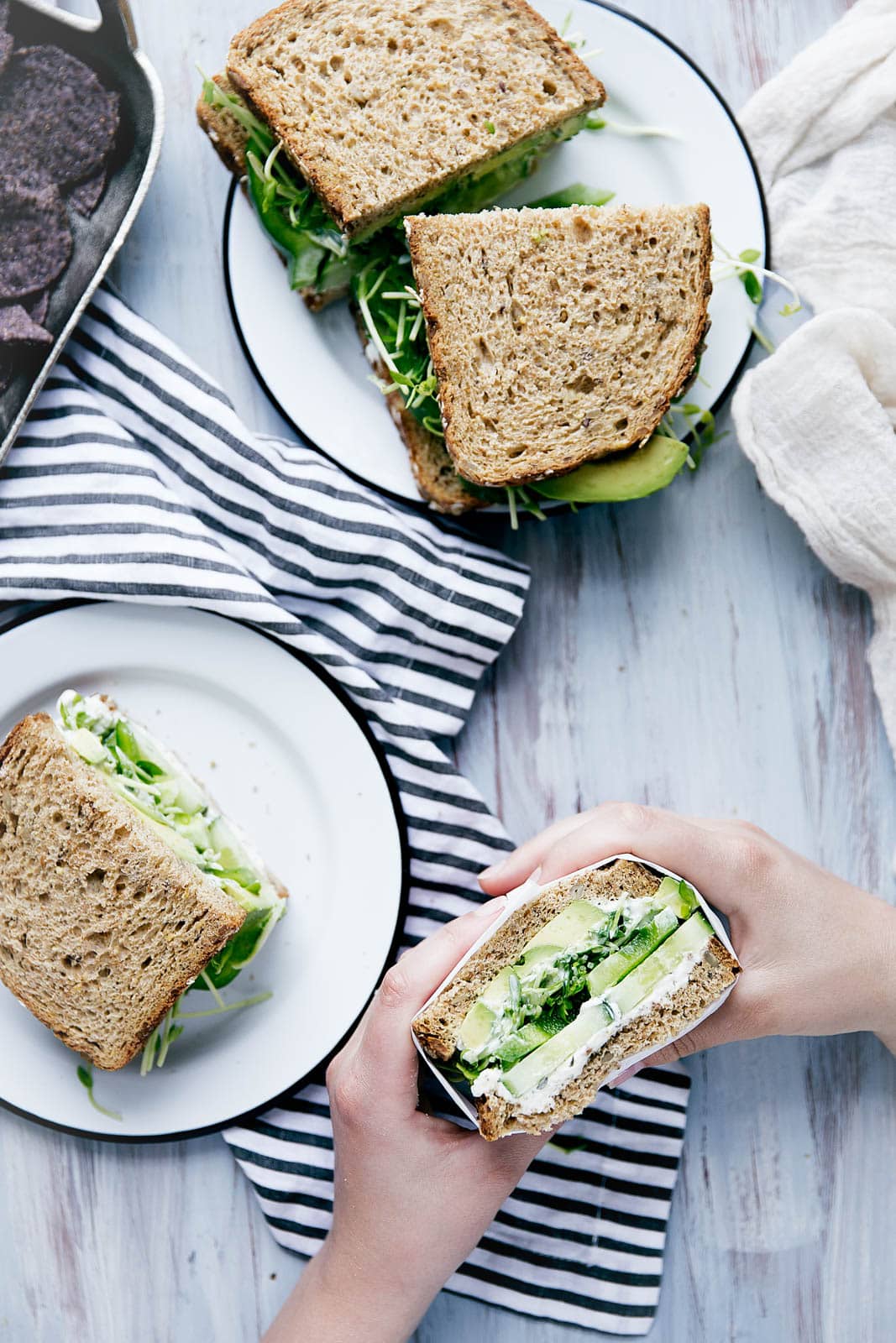 A green sandwich bursting at the seams with herbed goat cheese, avocado, alfalfa, and more.