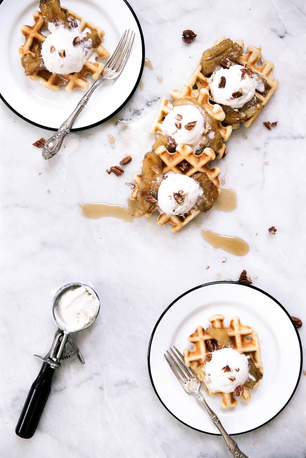 Bananas Foster Waffles made with vanilla ice cream, pecans, and caramelized rum bananas over a pillowy banana rum waffle. Yahm.