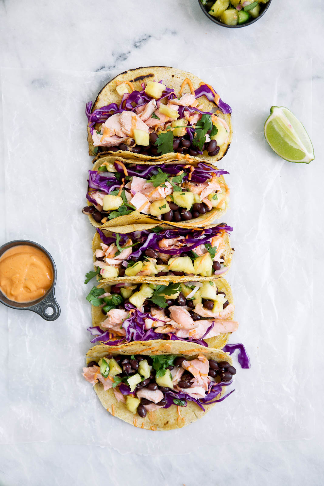 Coconut Salmon Tacos marinaded in coconut milk, lime, and ginger, complete with a homemade jalapeño pineapple salsa & sriracha mayo. A total hit for your next Taco Tuesday.