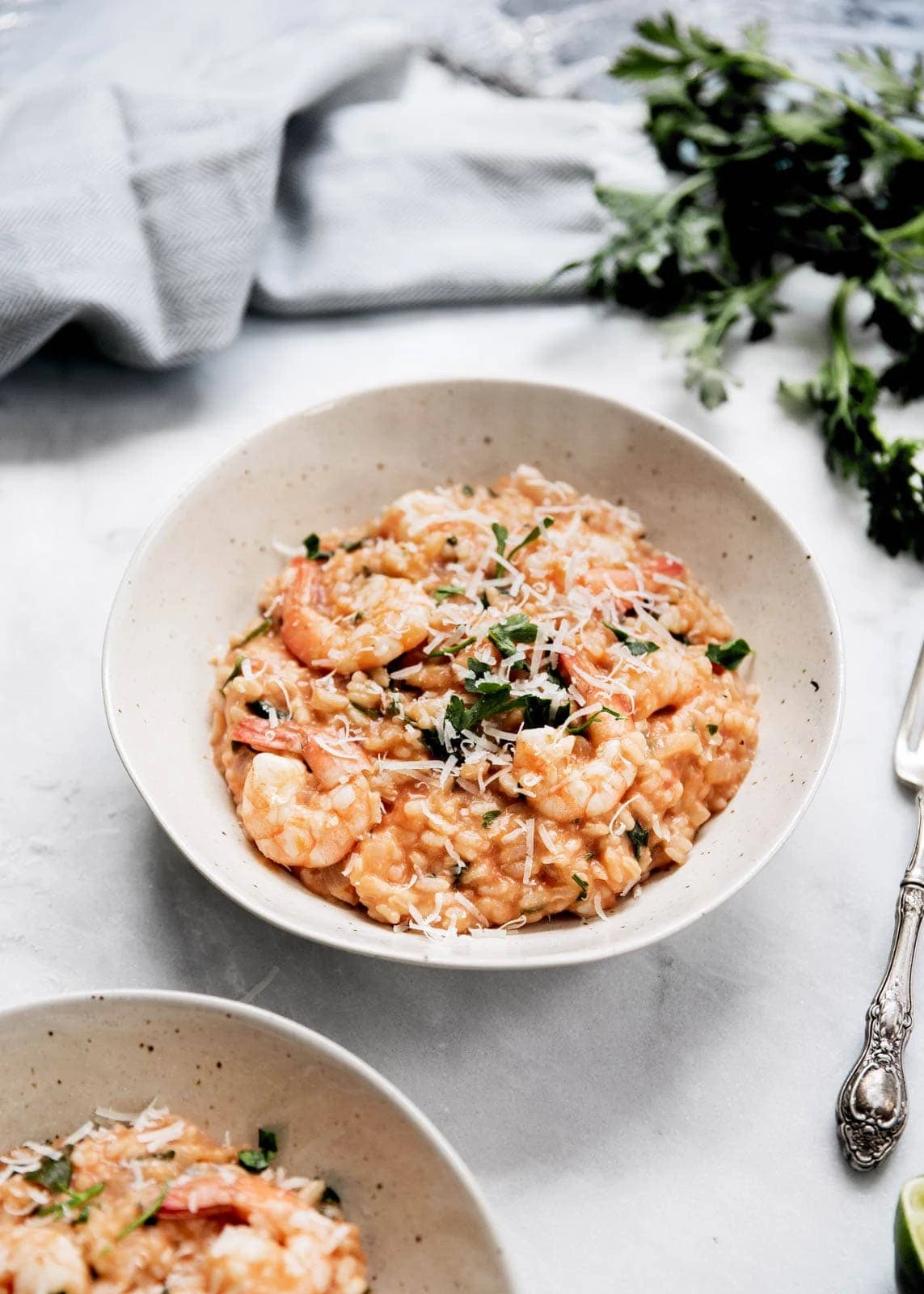 tomato and shrimp risotto in a white bowl