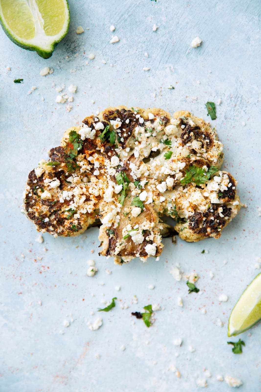 A play on Mexican street corn, these char-roasted cauliflower steaks are topped with a creamy chili lime sauce and cacique cheese!