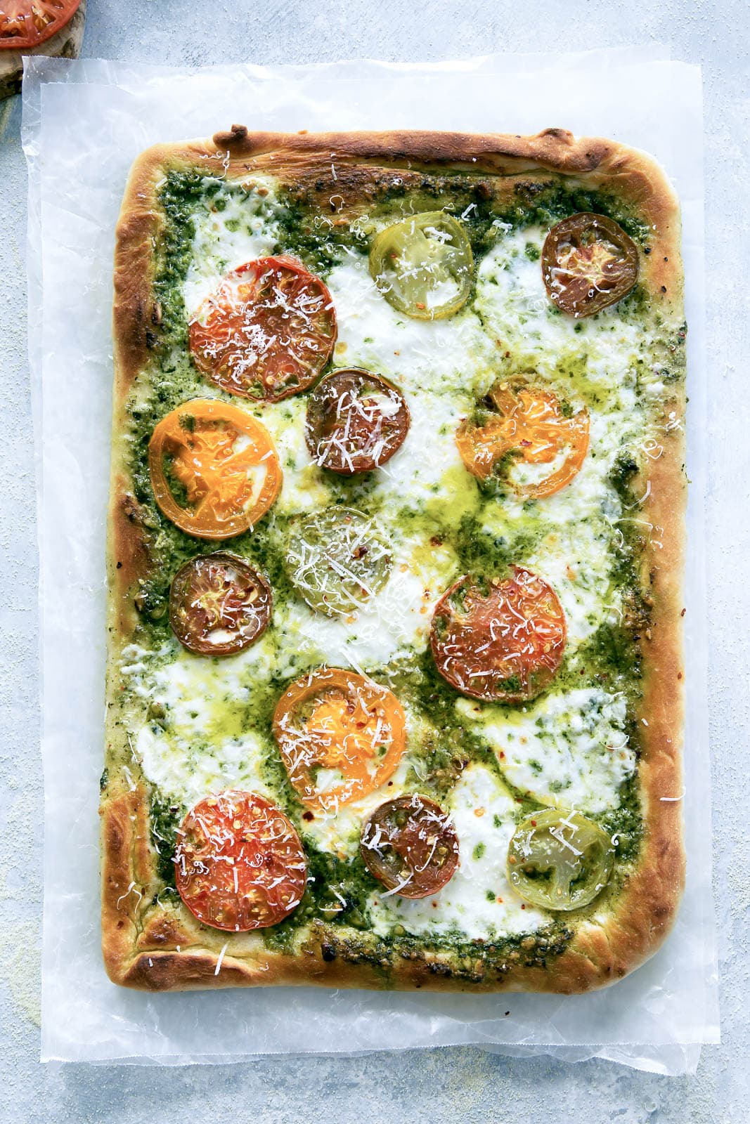 Say goodbye to heirloom tomato season with this ridiculously addicting heirloom tomato pesto pan pizza!