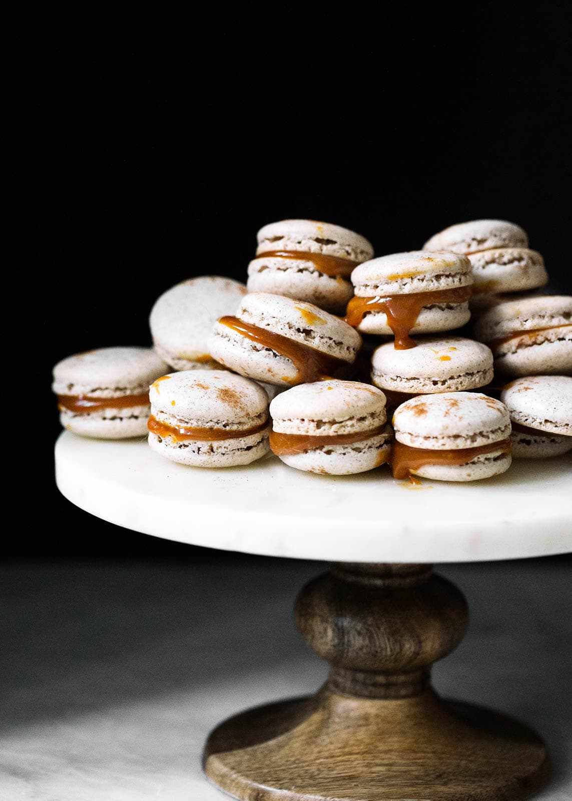 salted caramel macarons on a cake stand