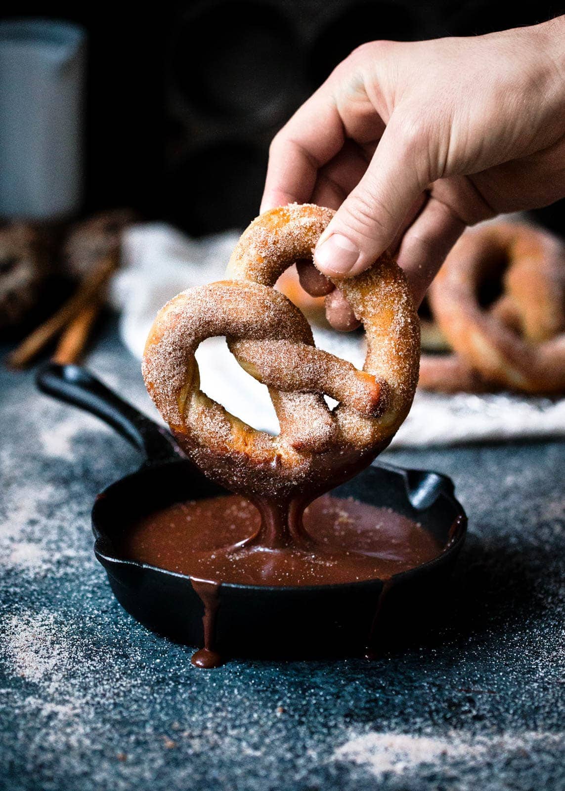 Even better than store-bought pretzels, these giant fluffy Cinnamon Sugar Pretzels with a sinful hot fudge dipping sauce make carb-o-loading so worth it.