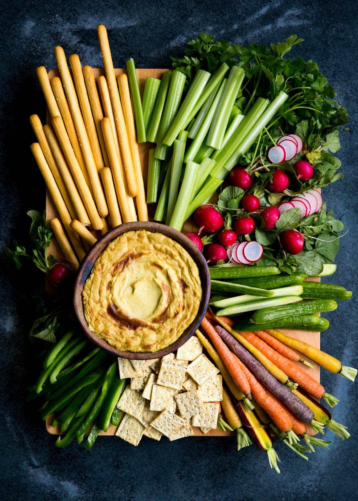 Mom's creamy, cheesy Artichoke Dip with a bountiful crudités is perfect for a crowd.