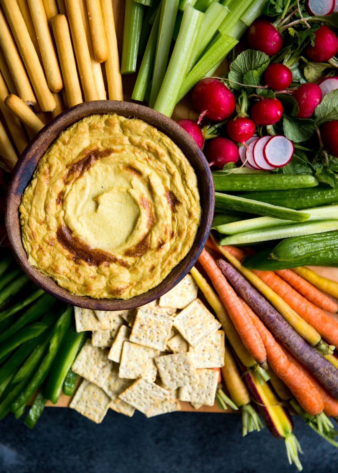 Mom's creamy, cheesy Artichoke Dip with a bountiful crudités is perfect for a crowd.