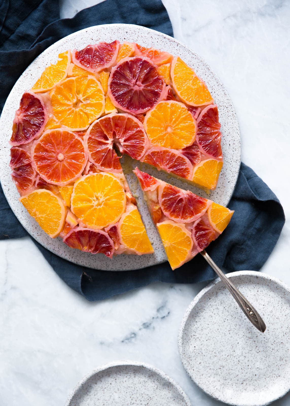 citrus cake with slice being removed