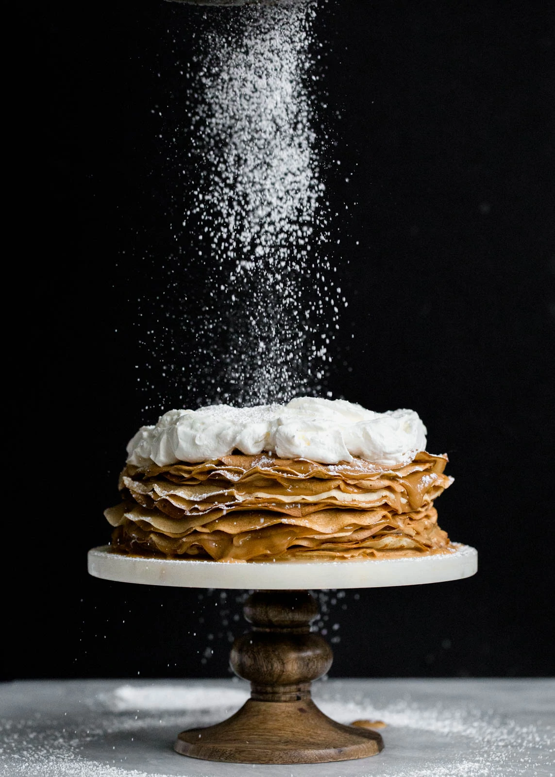 Layer after layer of banana crepes and dulce de leche, topped with whipped cream and bananas foster!