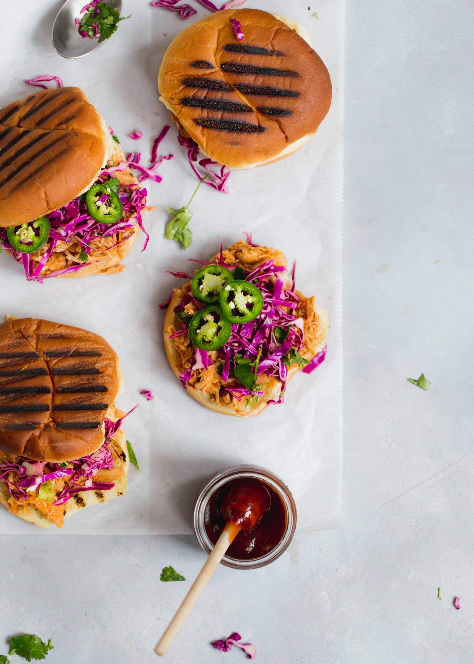 Slow Cooker Asian BBQ Pulled Chicken Sandwiches with a cilantro and purple cabbage slaw. No fuss and all flavor!