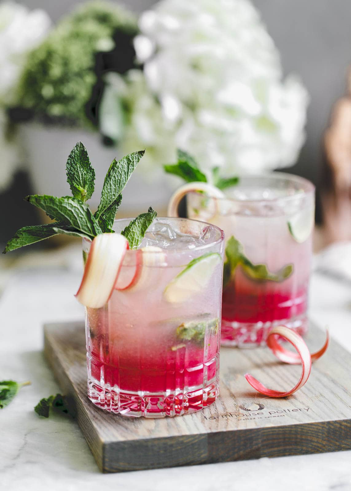 A thirst-quenching Rhubarb Mint Mojito made with rhubarb syrup, fresh mint, and lime. YUM.