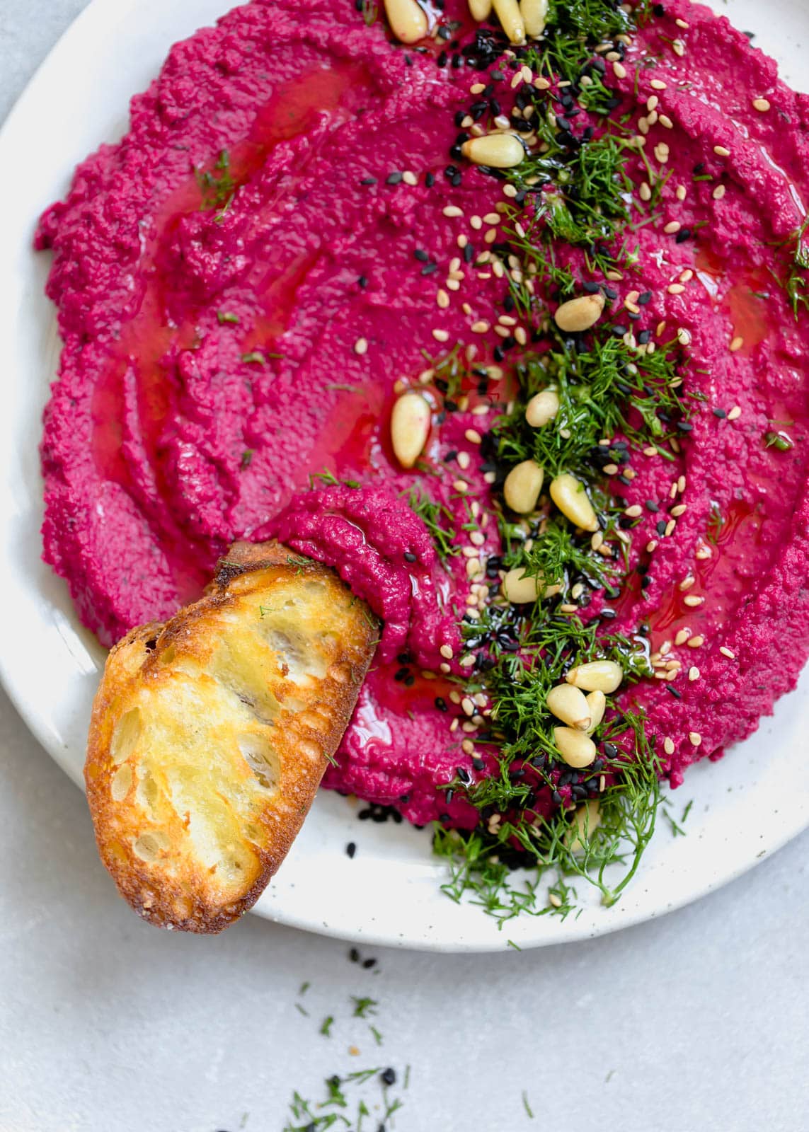 beet hummus with a slice of toasted bread