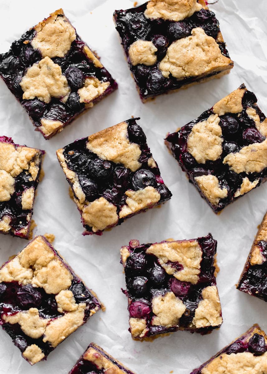 Whole Wheat Ginger Blueberry Crumble Bars with fresh blueberries. Perfect with a glass of cold milk.