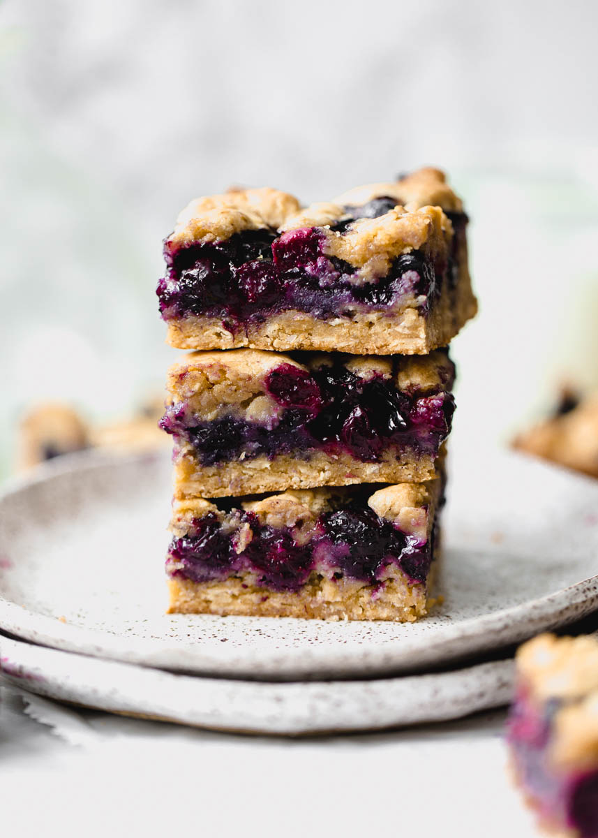 Whole Wheat Ginger Blueberry Crumble Bars with fresh blueberries. Perfect with a glass of cold milk.