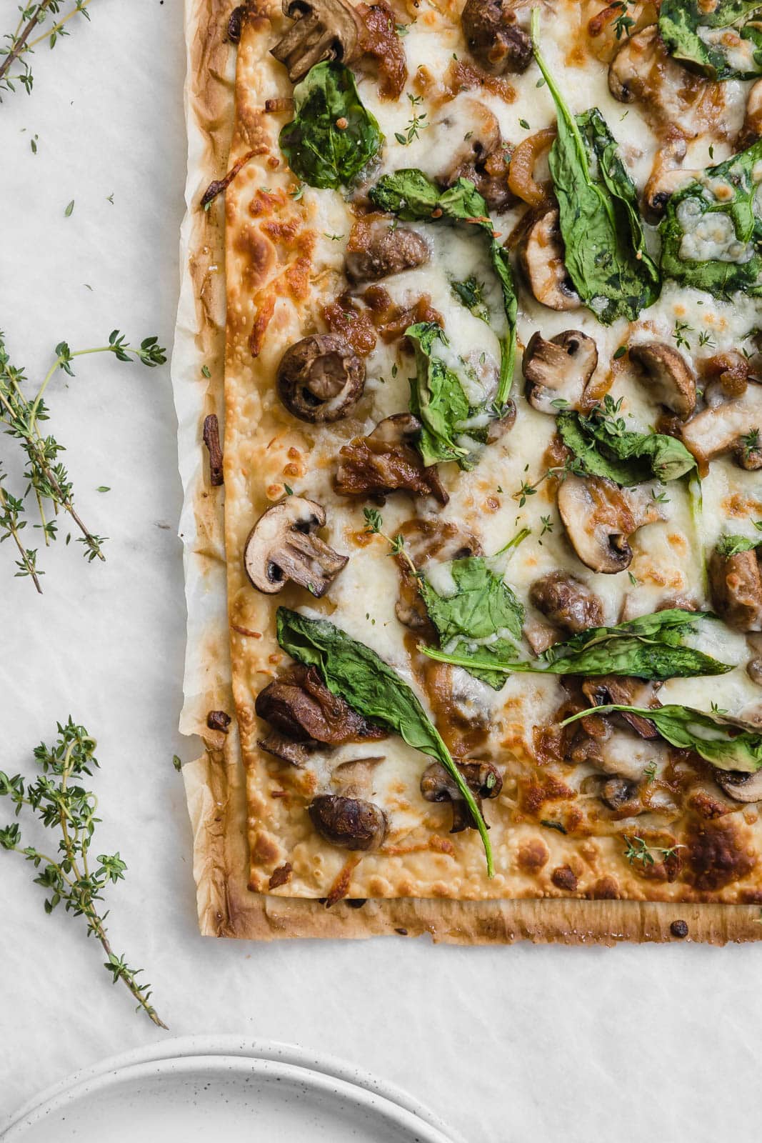 A thin crust Caramelized Onion Mushroom and Spinach Pizza perfect for those weeknights when you want a quick fix dinner!