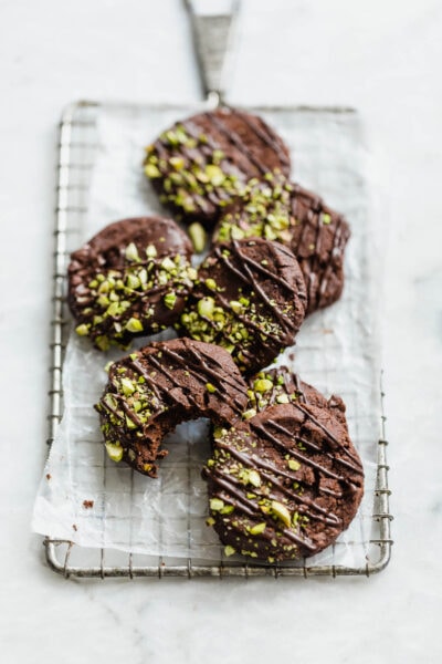 Delightfully rich and crunchy Chocolate Sable Cookies dipped in dark chocolate and coated in pistachio!