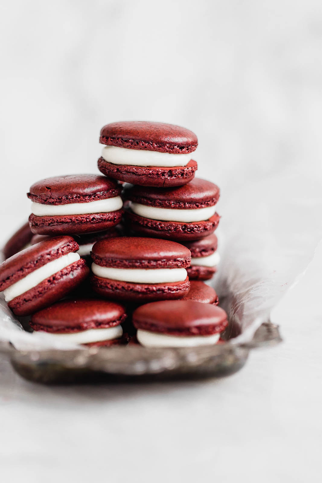 Decadent Red Velvet Macarons with a cream cheese frosting. Perfect for the holiday season, or just because!