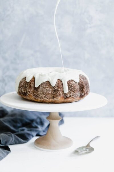 A total crowd-pleaser, this Cinnamon Bun Bundt Cake coated in cinnamon sugar and topped with a thick cream cheese glaze is EVERYTHING.