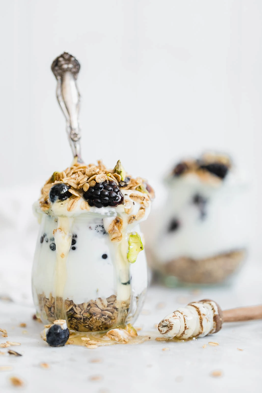 Cardamom Granola Parfait topped with honey and berries