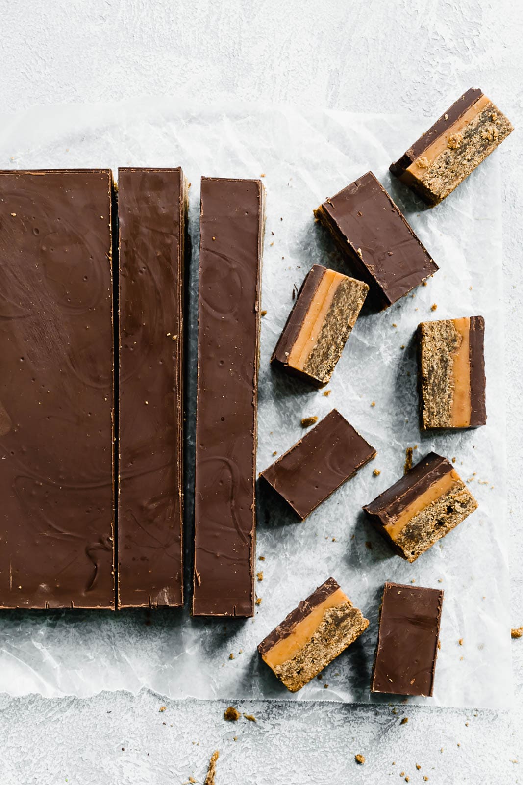 Classic Millionaire Bars get a twist with these Gingerbread Millionaire Bars! Made with spiced ginger shortbread, homemade chewy caramel, and chocolate!